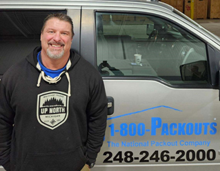 A person standing in front of a car

Description automatically generated